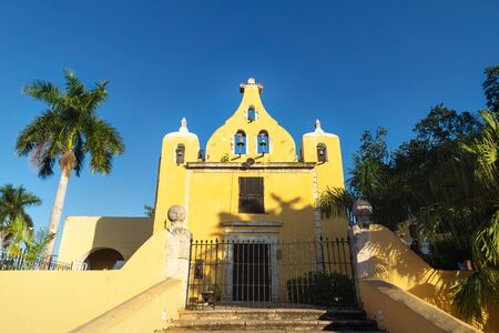 Yellow church with bell tower 'Santa Isabel' in Merida during cloudless sunny day, Yucatan, Mexicoの写真素材