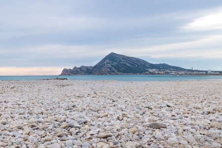 Panorama sunset with colorful cloudscape at the bright stone beach of Altea, Costa Blanca, Spainの写真素材