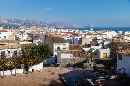 Outlook at the old town square Placa l'Aigua with sunny view over skyline and ocean with mountains and rock of Calpe, Altea, Costa Blanca, Spainの写真素材