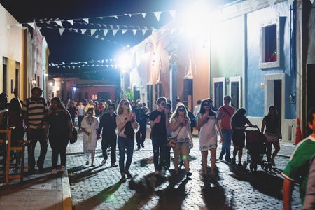 Merida, Mexico - 31 October 2018: Visitors with with catrina make up at the festival for day of the dead walking in a colonial street at nightのeditorial素材