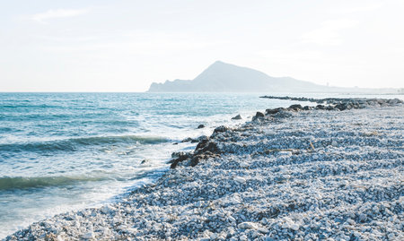 The destroyed stone beach in Altea after storm Gloria in January 2020 with view on mountain range, Altea, Costa Blanca, Spainの写真素材