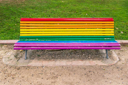 Colorful empty lgbt rainbow painted bench in a park in Valencia, Spainの写真素材