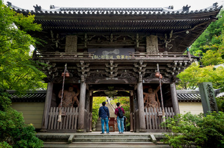 Miyajima, Hiroshima, Japan - 15 September 2017: Visitors looking at the gate entrance with nio kings...