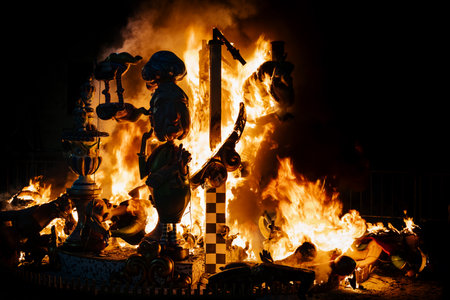 Gandia, Spain - 5 September 2021: At the traditional Fallas festival large paper mache figurines, here with a silhoutte of a granny, are displayed and burned at the end of the event, Gandia, Spainのeditorial素材