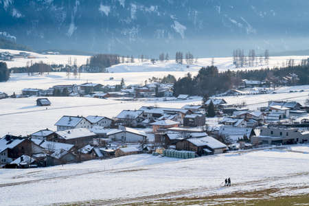 Walking in cold snow covered winter landscape in the mountain village Wildermieming, Tirol, Austriaの写真素材