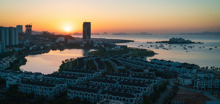 Sunrise at Ha Long Bay with view over the landscaped islands with construction sites in Halong City, Vietnamの写真素材