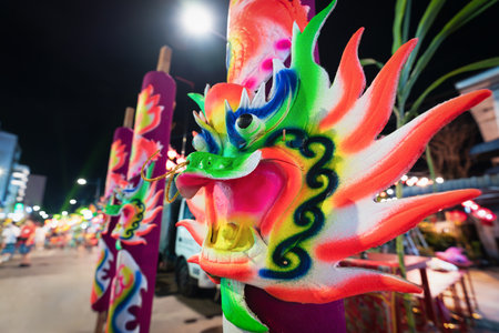 Huge neon colored incense sticks with dragon heads in front of Clan jetty temple in Georgetown, Penang, Malaysiaの写真素材