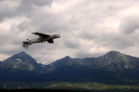 Small airplane doing aerial acrobatics at low altitude