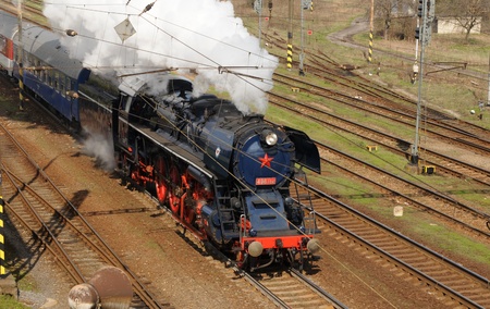 LiptovskÃ½ MikulÃ¡Å¡,Slovakia-April 2011: Steam locomotive Skoda Albatros pulling tourist...