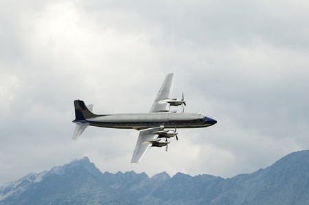 high tatras,slovakia-june 2011:red bull dc-6b -  high mountains of the tatra mountains in slovakia during the air show 25th 26th june 2011 at the airport in poprad, slovakia june 2011のeditorial素材
