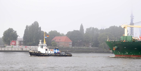 Hamburg Germany september 2012:Containership Hyndai in port of Hamburg container ship with red tugboatのeditorial素材