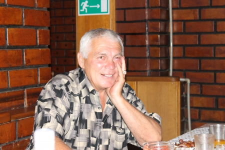 A man sits at a table and laughingの写真素材