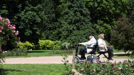 Details of seniors on electric scooter in urban park.のeditorial素材