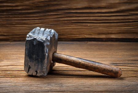 Generative AI Hammer with wooden handle kept on anvil in manufacturing industryの素材