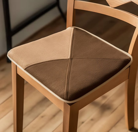 Generative AI An upholsterer fits a cushioned pad into a wooden chair. At an upholstery, furniture, or woodworking shop.の素材
