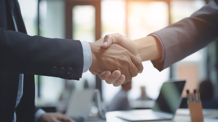 Business people shaking hands, finishing up a meeting. Two confident business man shaking hands duriの素材