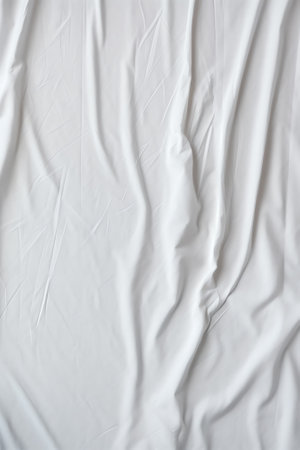 Top view of wrinkles on an untidy white bed sheet in a bedroom after a long night sleep and waking uの素材