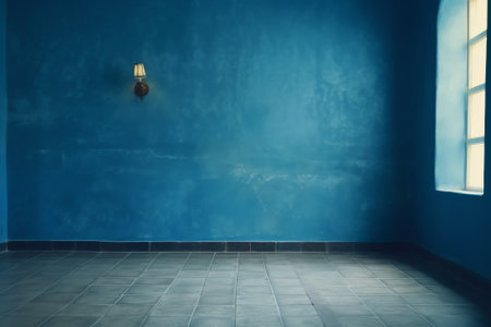 Dark blue wall in an empty room with a concrete floorの素材