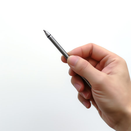 Generative AI : A close up isolated students hand holding a pen writing during class exam or lesson time at school Bright colors and second student blurred in the backgroundの素材