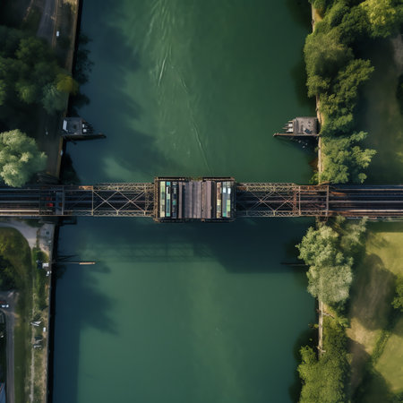Generative AI : Aerial drone view of modern aqueduct or water bridge is constructed to convey watercourses across gaps showing a sailboat moving over the infrastructure and vehicleの素材