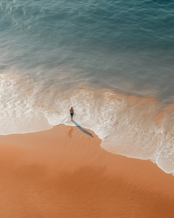 Generative AI : Aerial view of a person walking on the beach on the shoreline Ionian Sea Peschici Foggia Gargano Natural Park Puglia Italyの素材