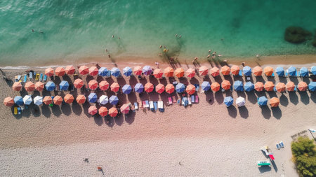 Generative AI : Aerial view of a lone orange parasol in a tranquil beach SantAndrea Apostolo dello Ionio Calabria Italyの素材