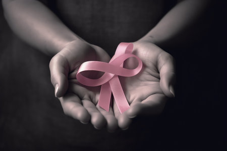 Generative AI : Close up hands holding the orb and Awareness ribbons of common cancer in the wood deskThreat from cancer Social campaign against cancer conceptElements of this imagの素材