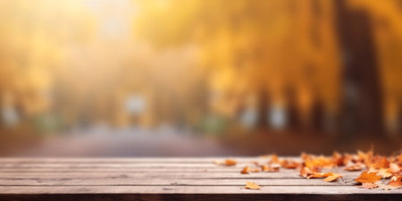 Generative AI : Beautiful autumn nature background with border of orange gold and red maple leaves on background of sunlight with soft blurred bokeh and empty wooden table planksの素材