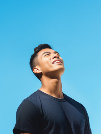 Generative AI : Candid of young attractive asian man close eyes deep breath and wide open arms in blue sky view background feeling wind and sunshine Happy asian hipster male in youの素材