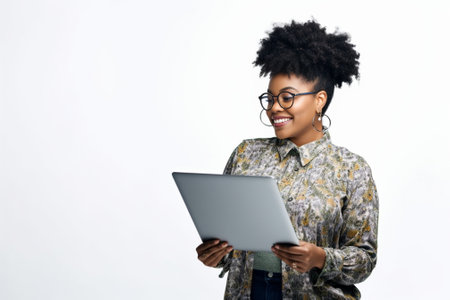 Confident business expert Confident young African woman working on laptop while standing against white background : Generative AIの素材