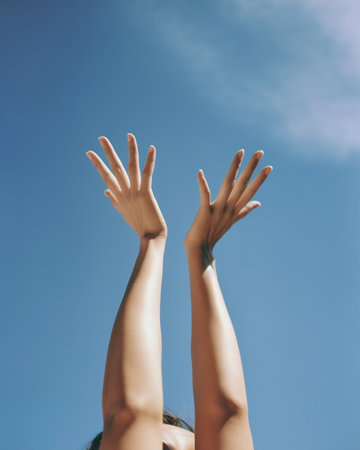 Beautiful young Ukrainian woman stretching out hand with blue sky in the background : Generative AIの素材