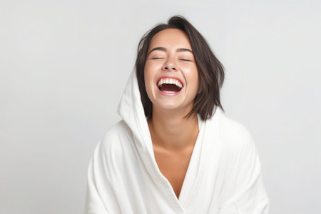 Always clean and fresh Beautiful young woman wrapped in towel keeping arm raised and smiling while standing against grey background : Generative AIの素材