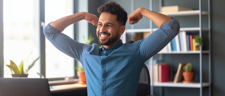 Everyday winner Cheerful young man in casual wear keeping arms raised and looking happy while sitting at the desk in office : Generative AIの素材