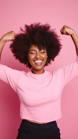 Happy woman in sports clothing carrying a bag and keeping arm raised against pink background : Generative AIの素材