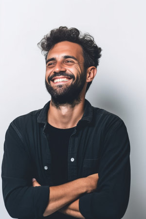 Happy bearded man Handsome young bearded man keeping arms crossed and smiling while standing against grey background : Generative AIの素材