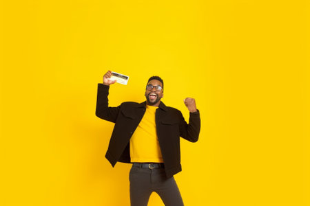 Excited mixed race man falling on the couch with yellow background : Generative AIの素材