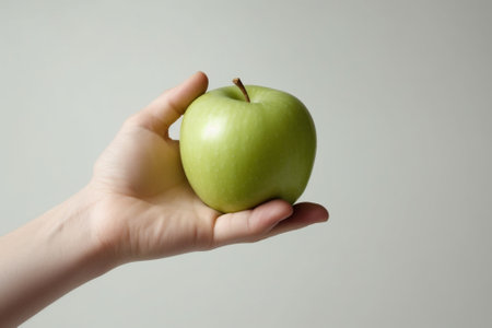 Childs white hand touching the green pear on a brunch Copy space : Generative AIの素材