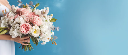 Indoor shot of pleased woman with curly hair points with fore finger upwards holds bouquet of spring flowers expresses happiness isolated over blue background empty space : Generative AIの素材