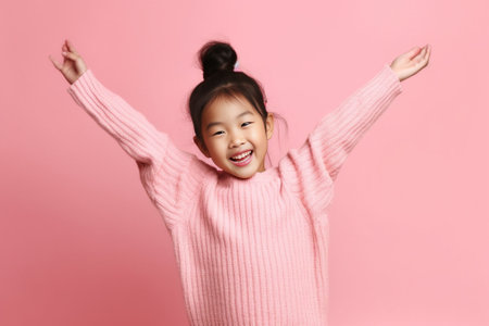 Happy playful pretty feminine girl raises palms has glad expression enjoys spare time tilts head smiles gladfully plays with small kid dressed in casual wear poses agains : Generative AIの素材