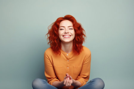 Happy cheerful young Caucasian red haired female with bun smiling cheerfully keeping hands on her stomach feeling full after dinner or cant stop laughing at some really g : Generative AIの素材