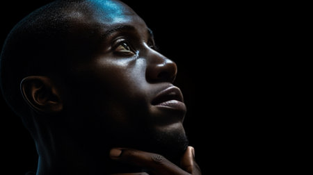 Close up portrait of darkskinned student with pensive and concentrated expression trying to recollect something standing at blackboard Thoughtful serious black man wearin : Generative AIの素材