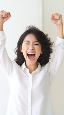 Cheering happy young Caucasian female with pure skin and beautiful appearance clenching fists being excited of success Joyful woman screaming with happiness to achieve he : Generative AIの素材