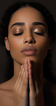 Vertical shot of miserable attractive female keeps palms pressed together has eyes full of belief prays for good wellness looks with sorrowful and hopeful expression upwa : Generative AIの素材