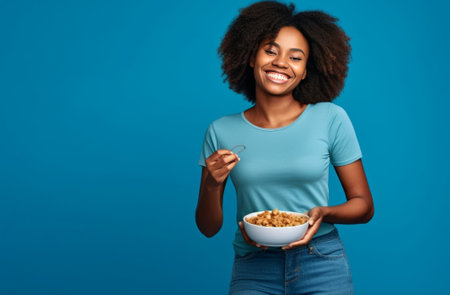 Pleased cheerful Asian woman keeps hand on belly feels full after delicious dinner dressed casually stands thoughtful against blue background Happy young female finds out : Generative AIの素材