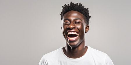 Handsome unshaven young dark-skinned male laughing out loud at funny meme he found on internet, smiling broadly, showing his white straight teeth. Positive human facial e : Generative AIの素材