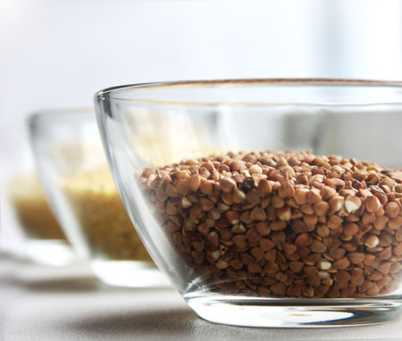 Three grains (couscous, rice, buckwheat) in glass bowlsの写真素材