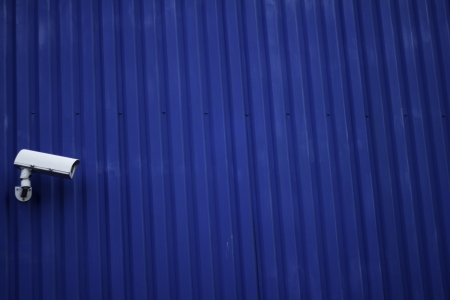 A CCTV camera on a blue buildingの写真素材