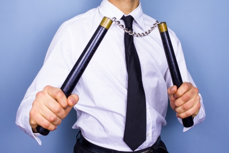 Businessman with nunchucksの写真素材