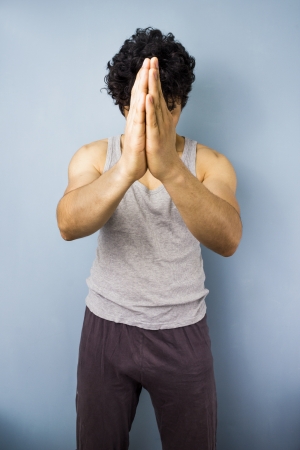 Young multiracial man in praying yoga poseの写真素材
