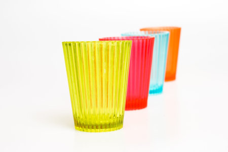 Colorful shot glasses isolated on whiteの写真素材